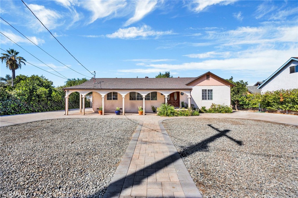 a front view of house with yard and mountain view in back