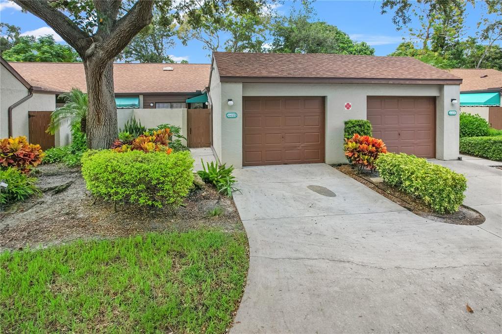 a front view of a house with a yard and a garage