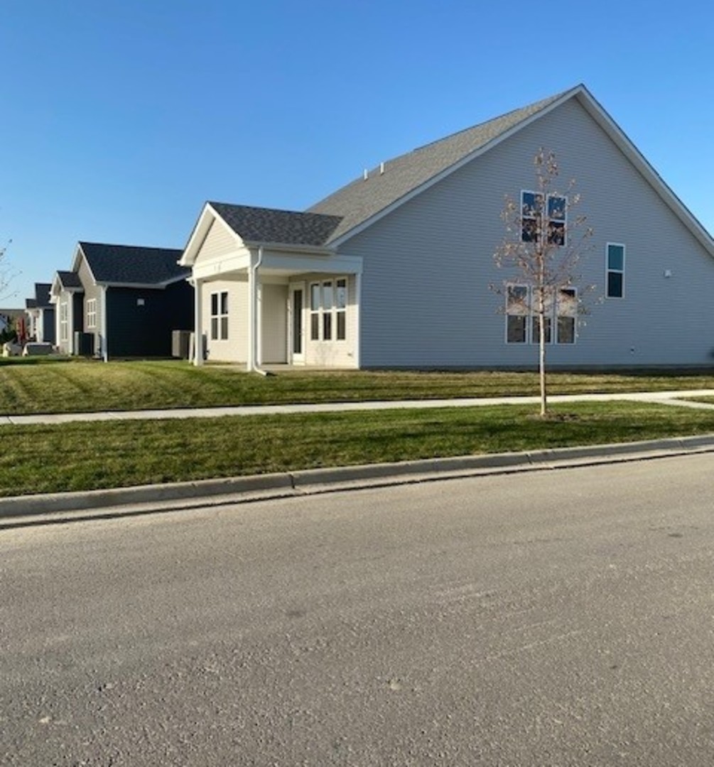 a front view of a house with a street