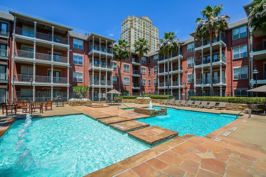 a front view of building with yard outdoor seating and swimming pool