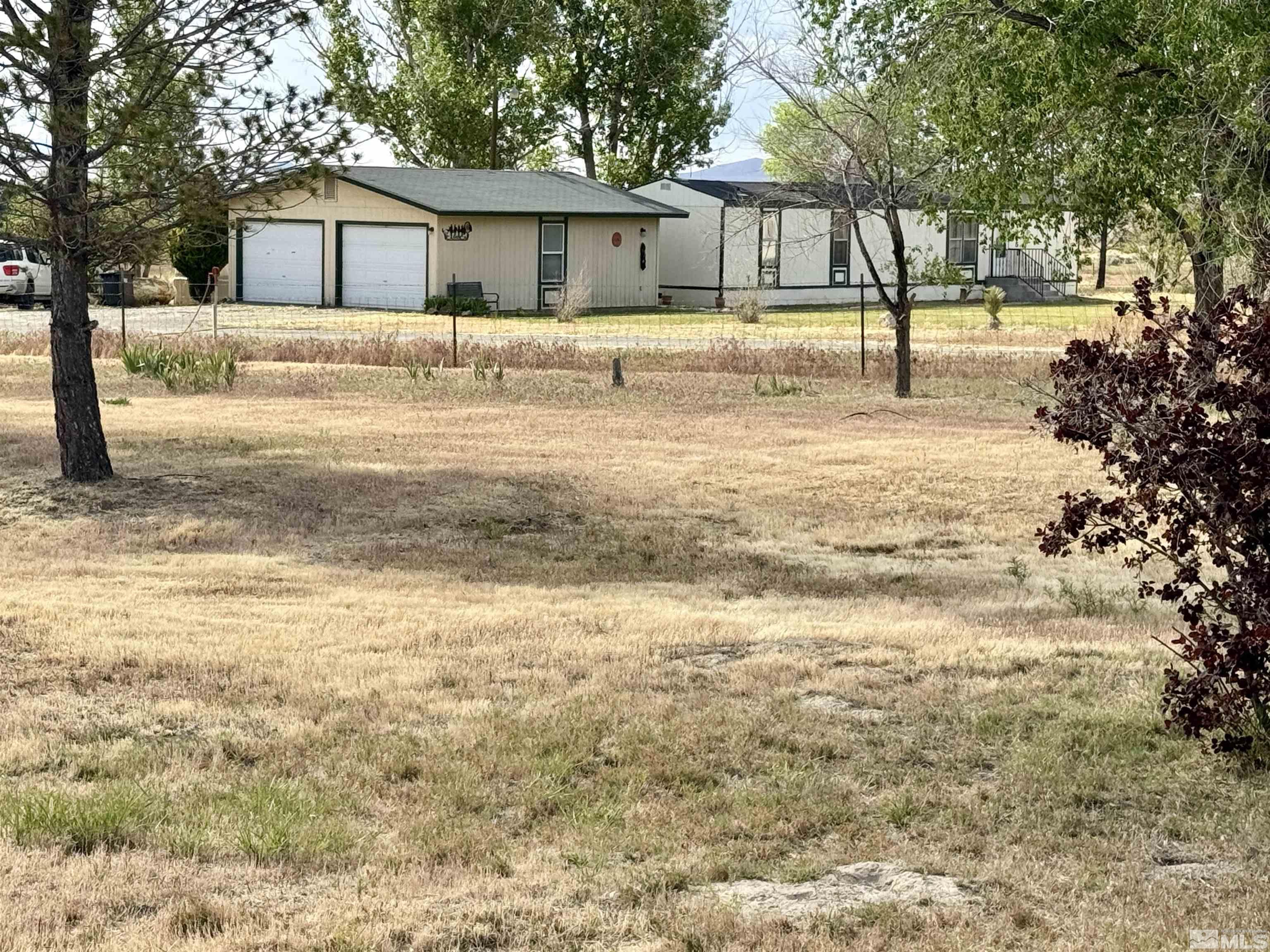 a view of a house with a yard and tree s