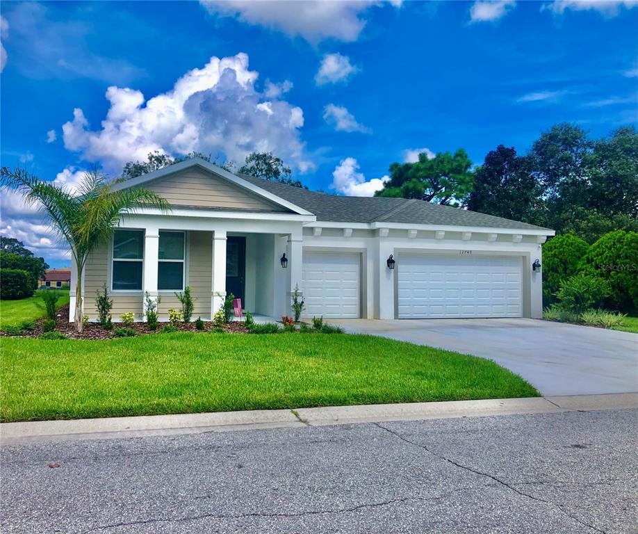 a front view of a house with a yard and garage