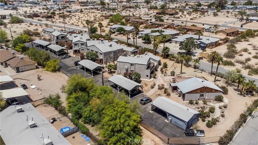 an aerial view of multiple houses with yard