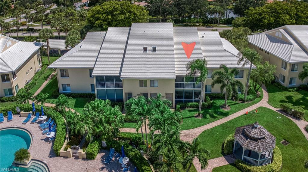 a aerial view of a house with swimming pool and furniture