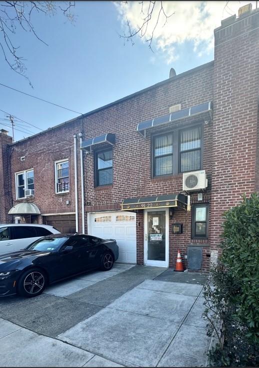 a car parked in front of a brick building