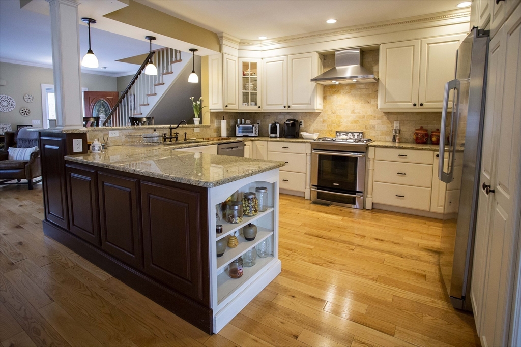 a kitchen with stainless steel appliances granite countertop a stove and a refrigerator