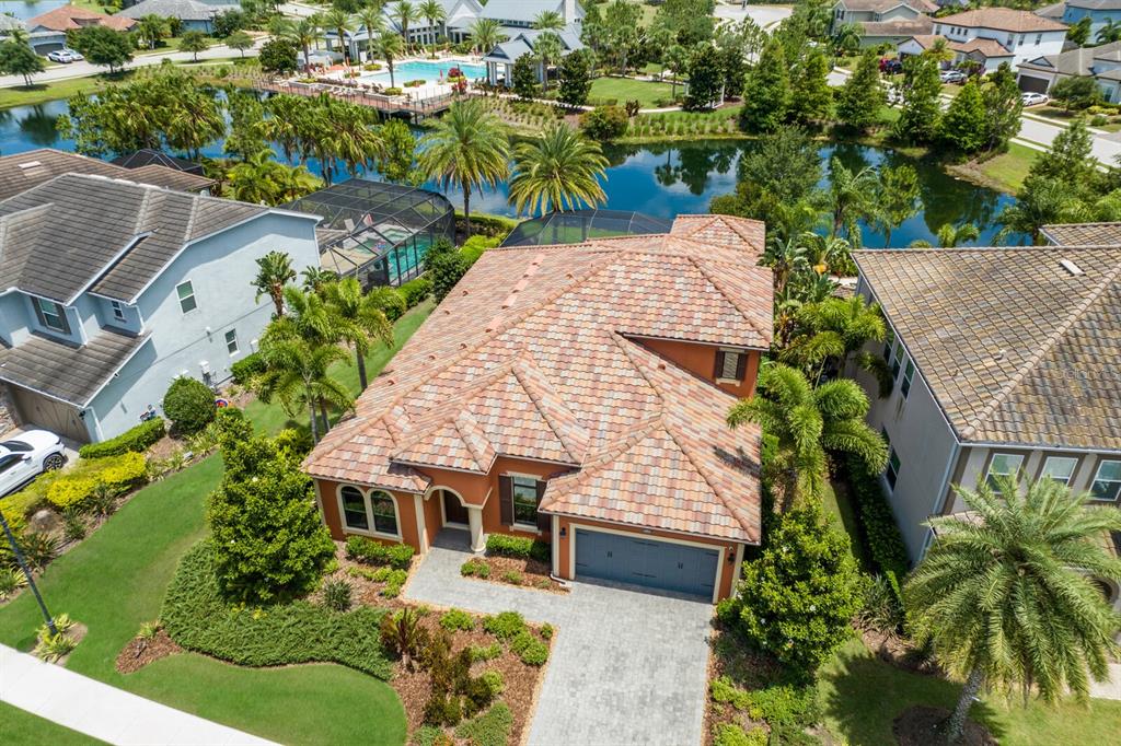 an aerial view of a house with a yard and potted plants