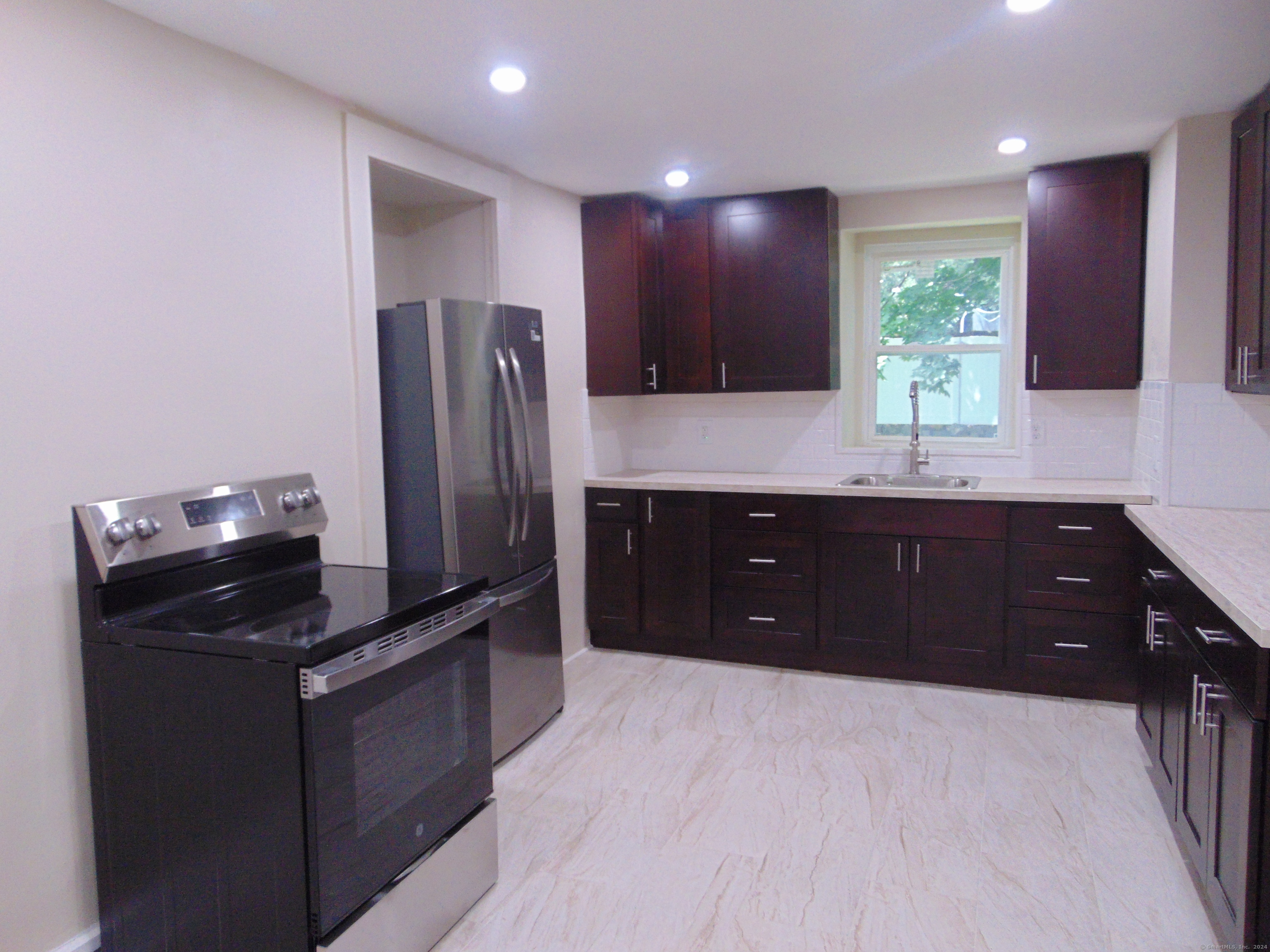 a kitchen with a refrigerator and a sink