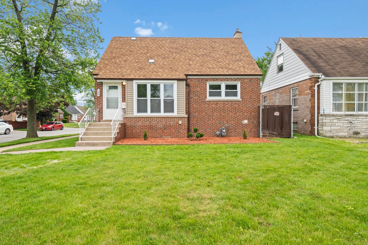 a front view of a house with a garden and plants