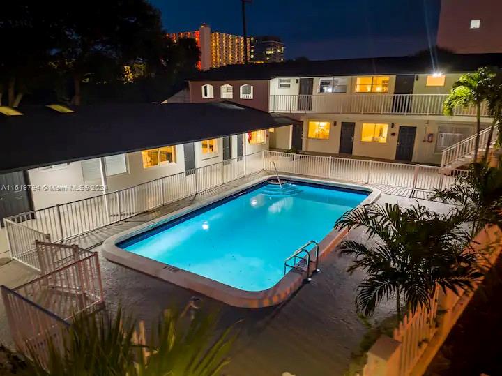 a swimming pool with outdoor seating and yard