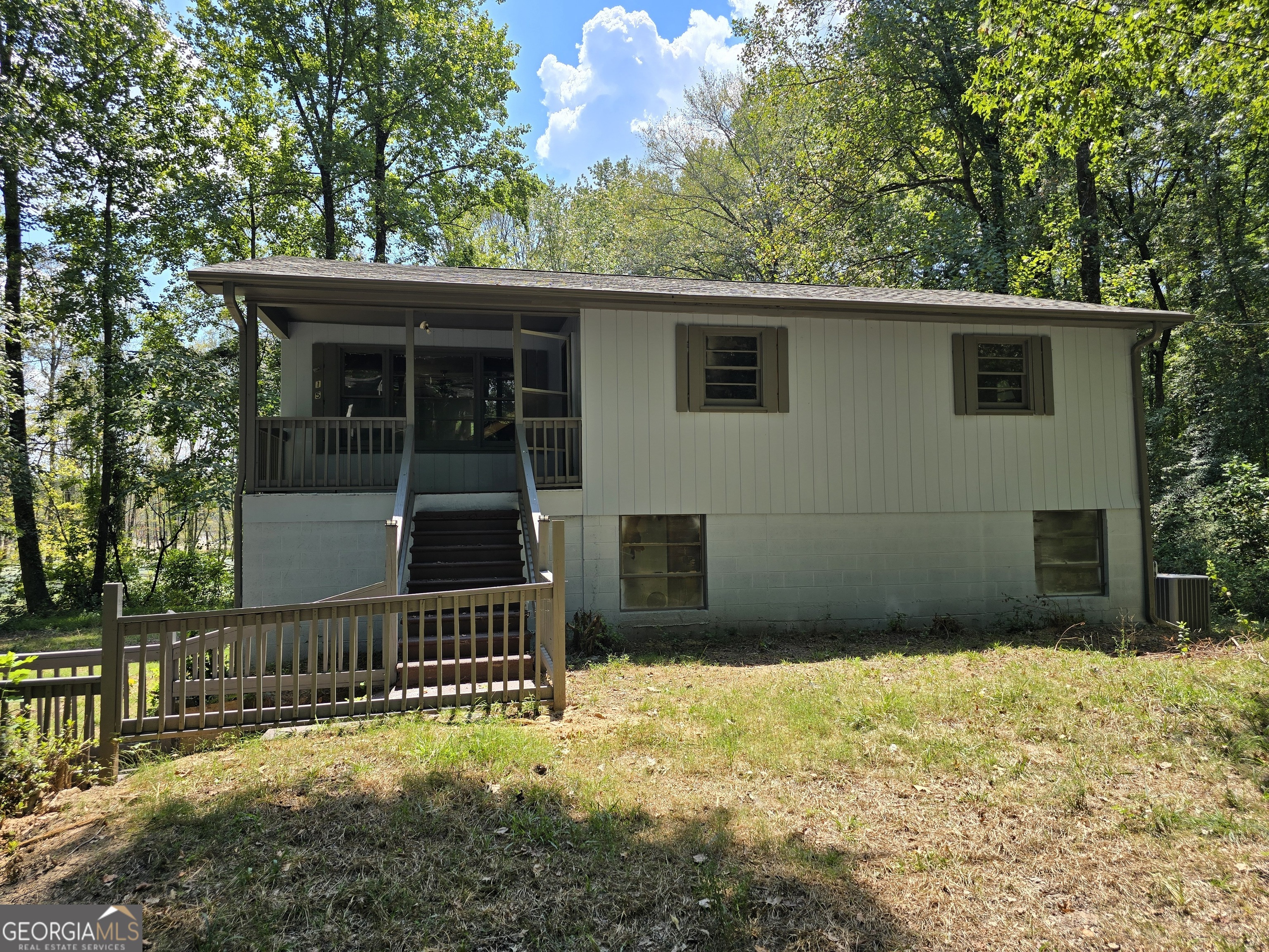 a view of house with backyard and trees