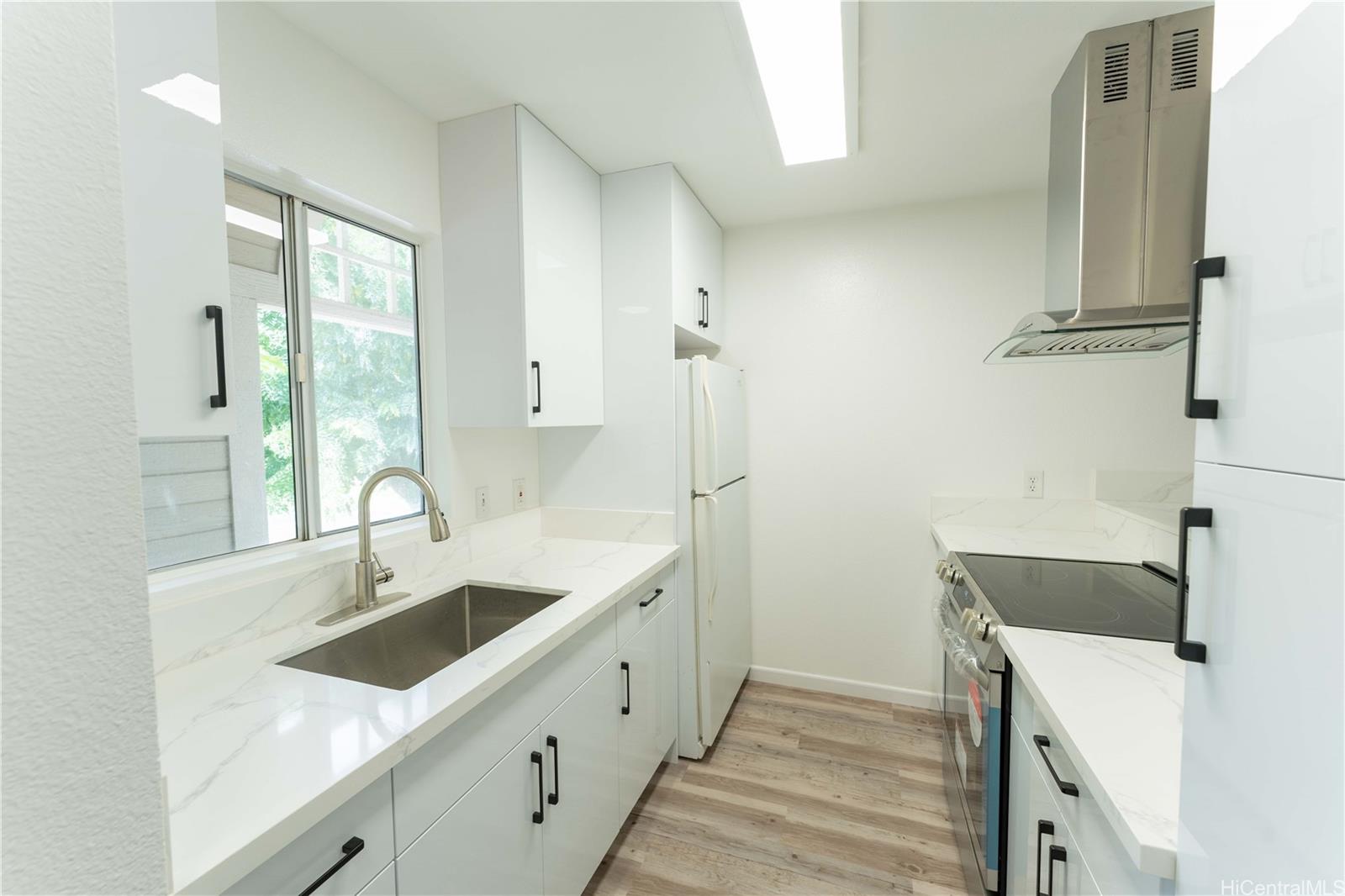 a kitchen with a sink and a refrigerator