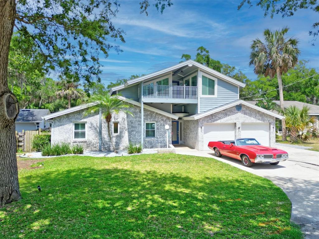 a front view of house with yard and green space