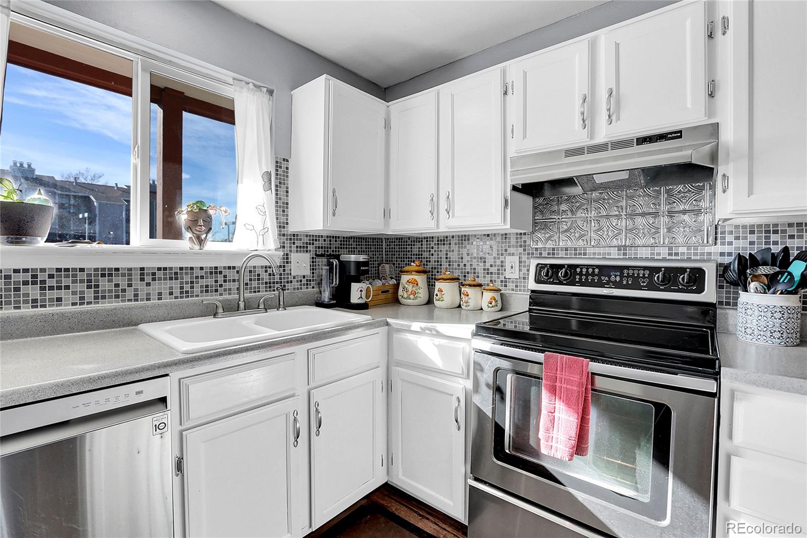 a kitchen with appliances a sink and cabinets