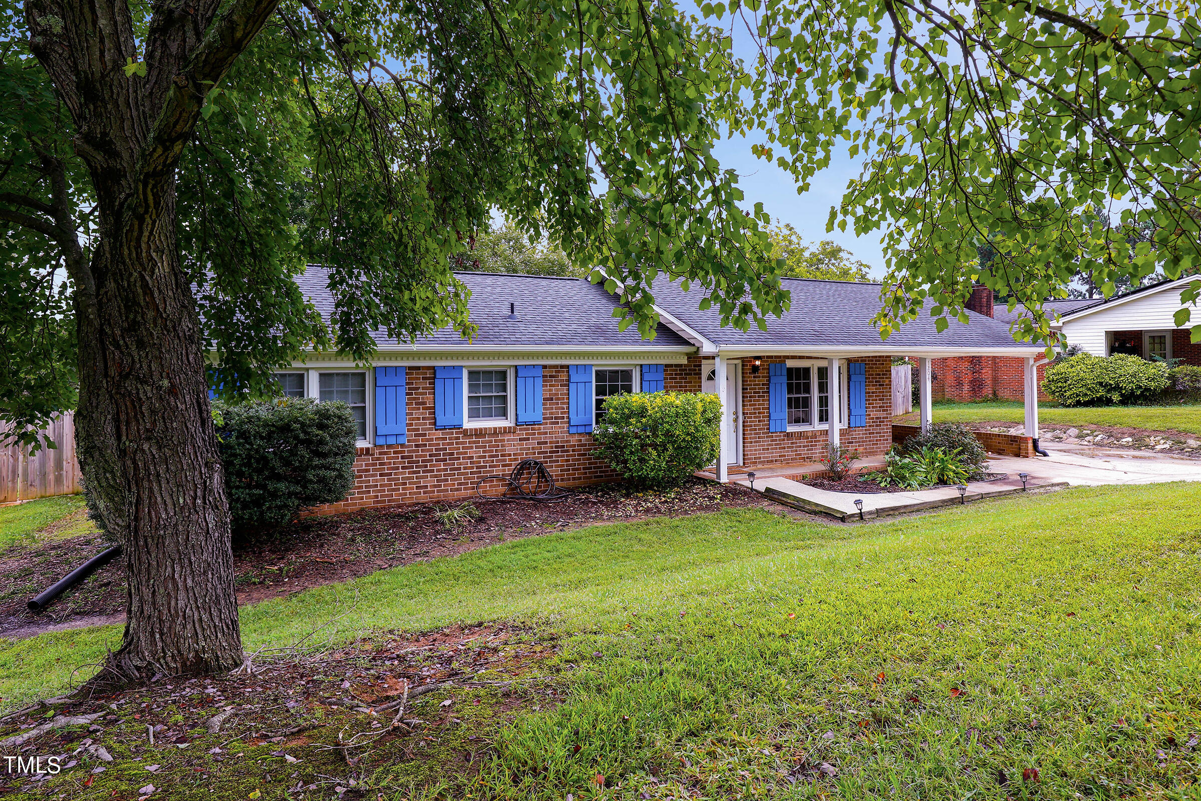 a front view of a house with a yard and porch