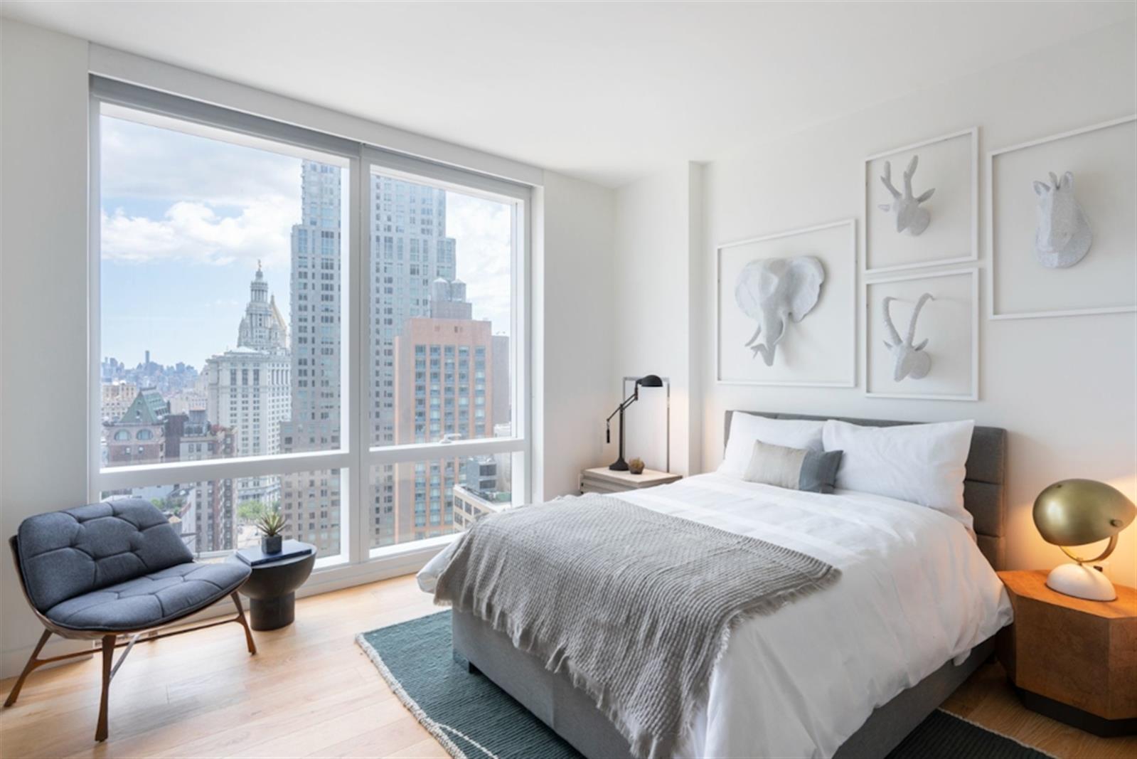 a bedroom with a bed and a large window