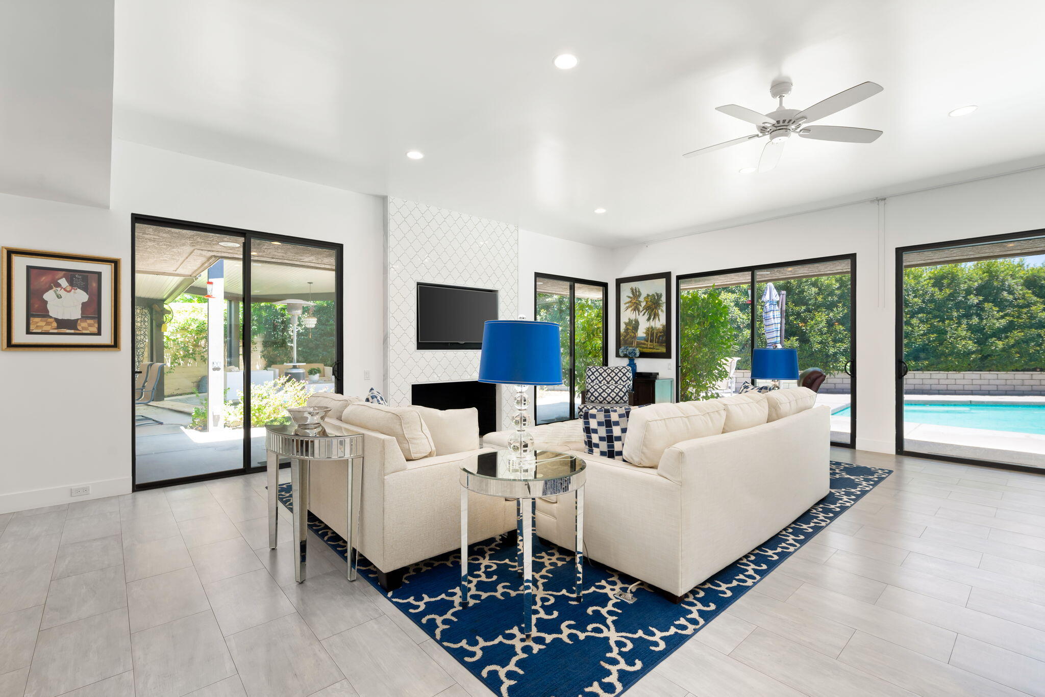 a living room with furniture large windows and a flat screen tv