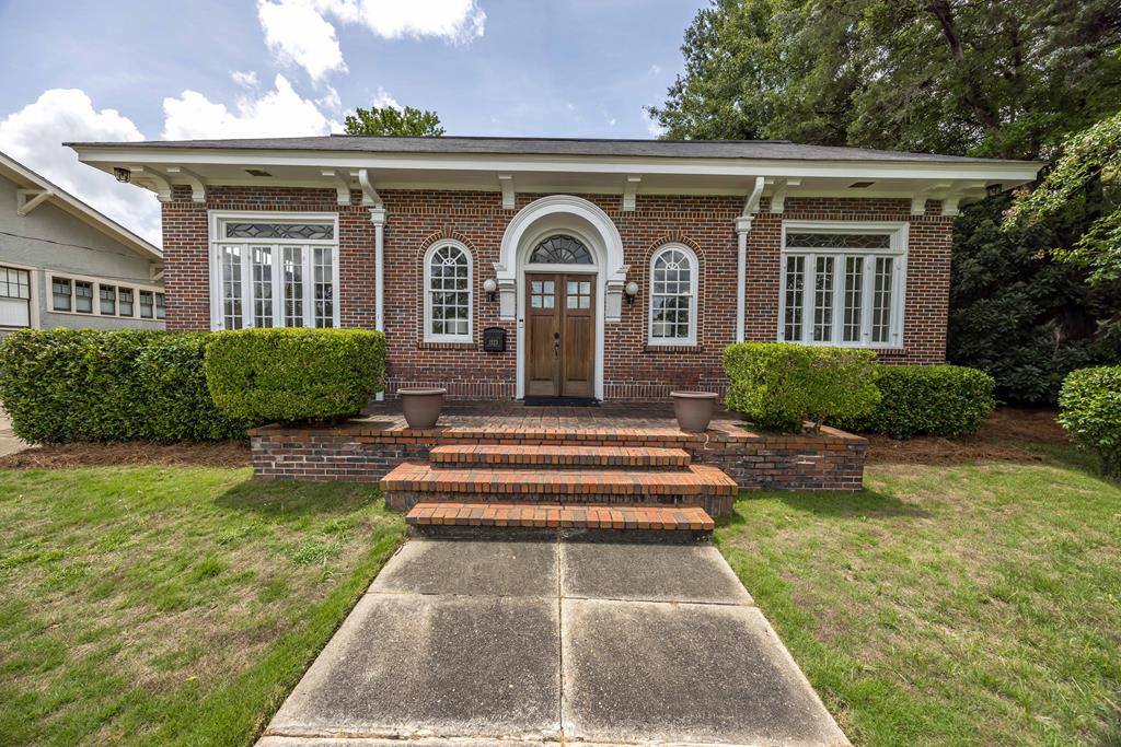 a front view of a house with garden