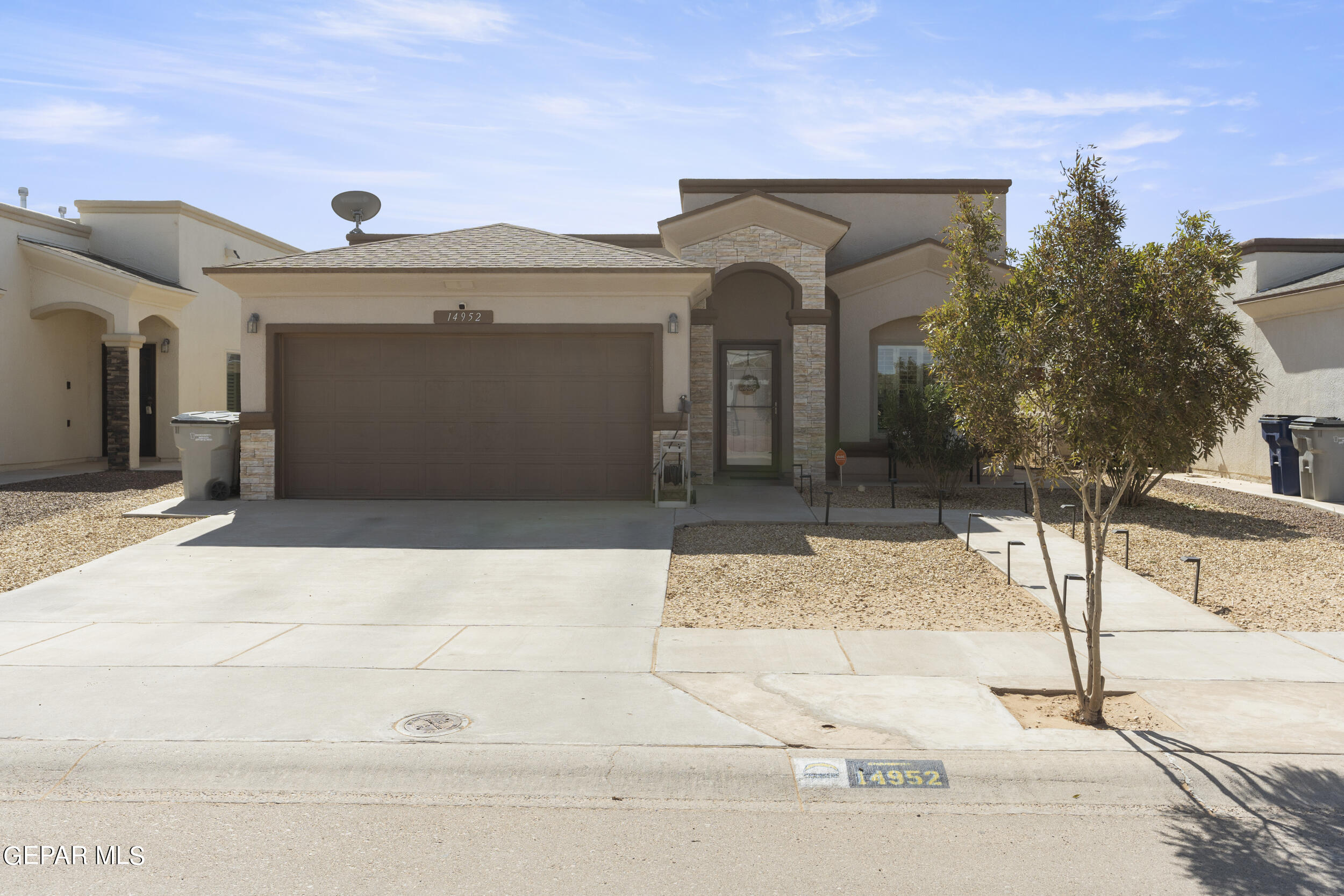 a front view of a house with a garage