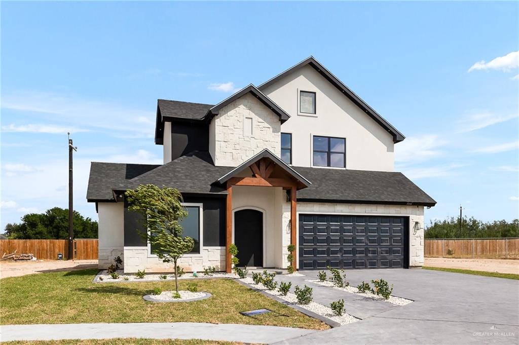 View of front of home featuring a garage and a front lawn