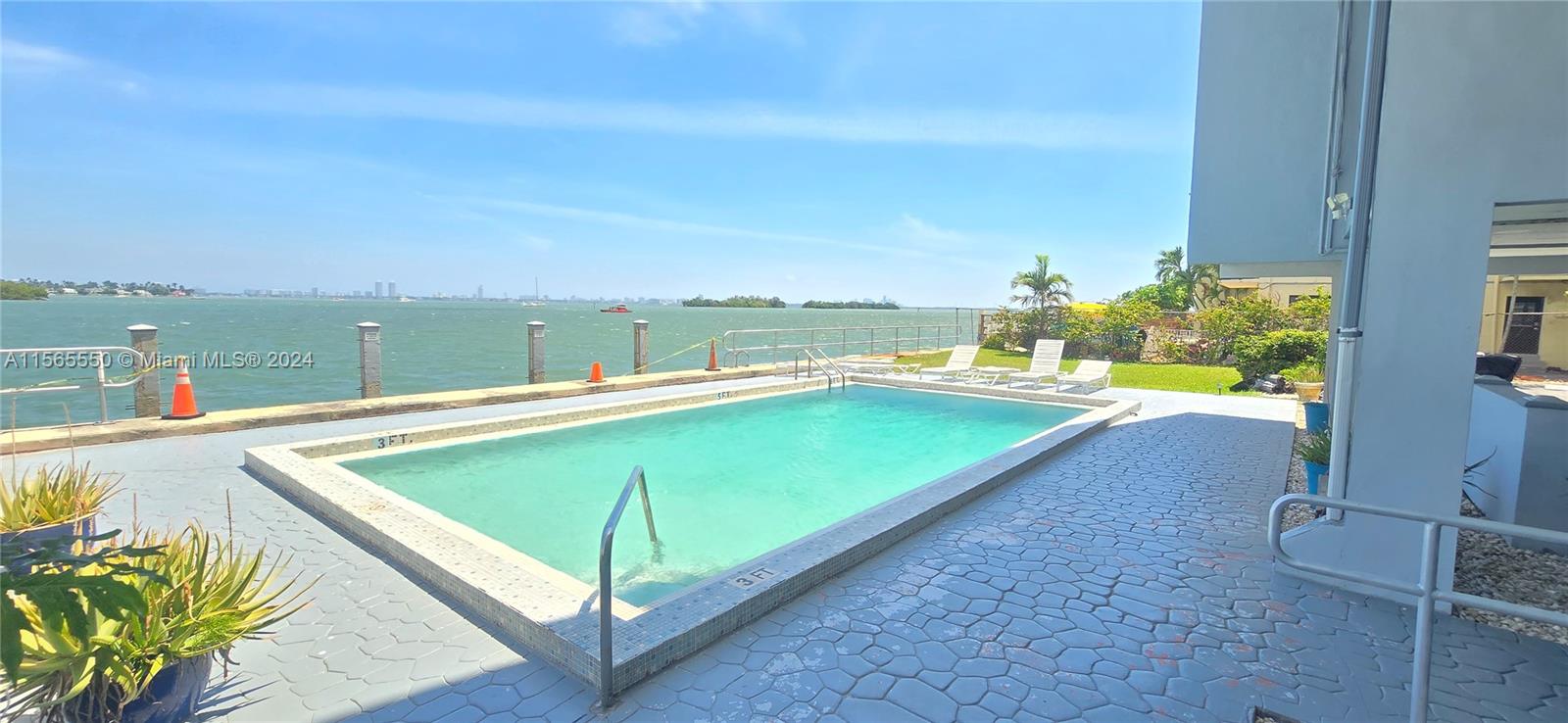 a view of a pool in a backyard of a house