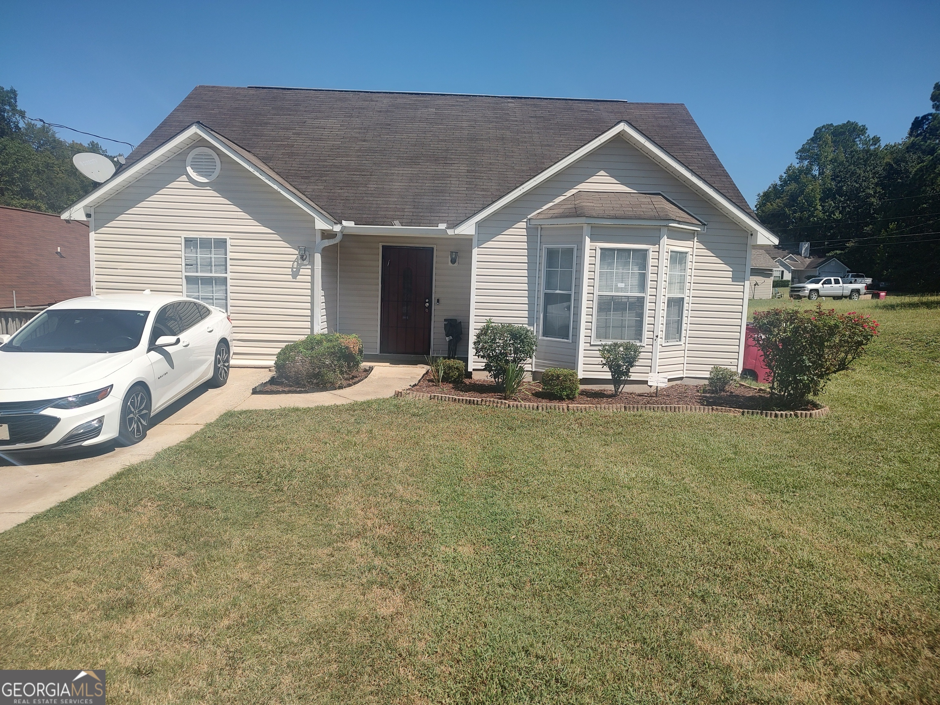 a front view of house with yard and seating space