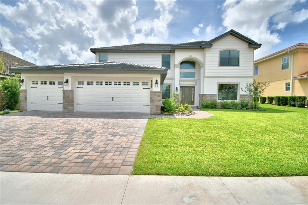 a front view of a house with garden