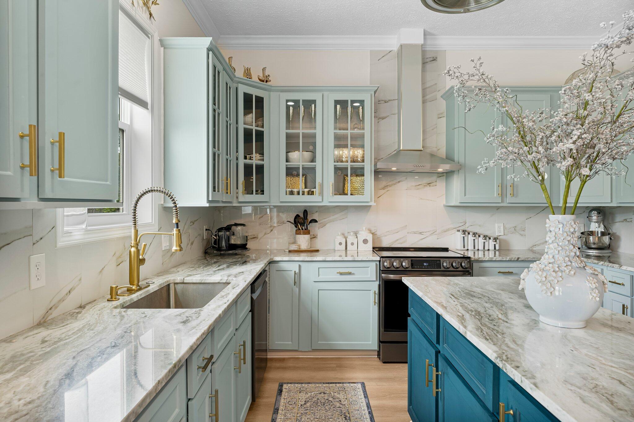 a kitchen with granite countertop a sink a stove and cabinets