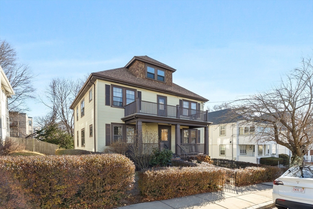 a front view of a residential apartment building with a yard