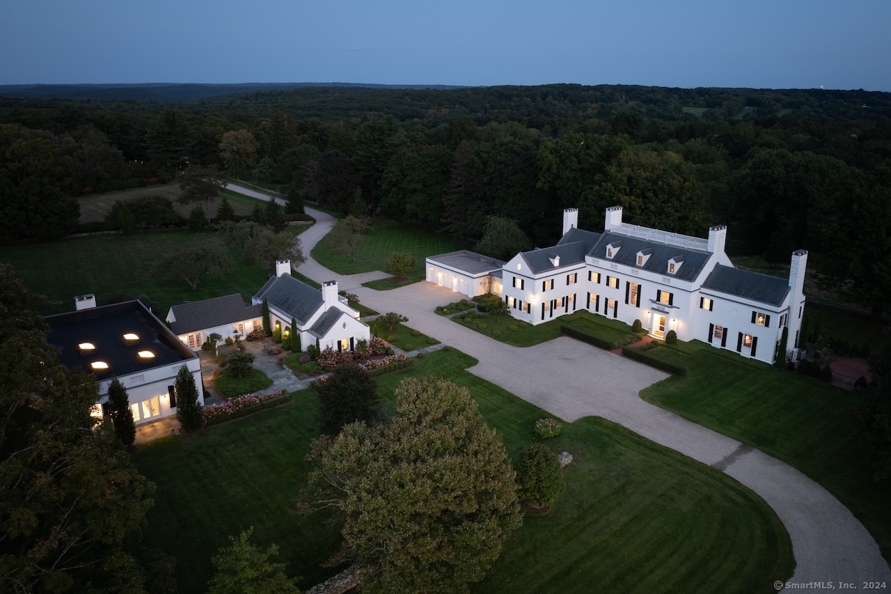 an aerial view of a house with garden space and street view