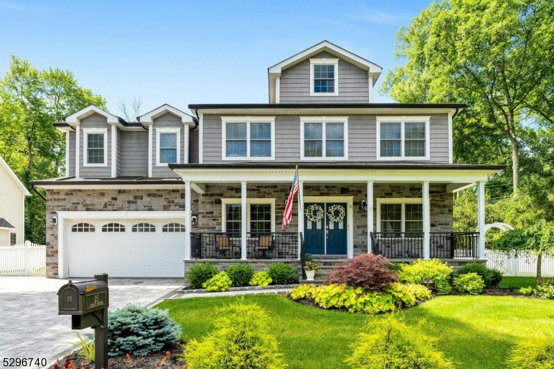 a front view of a house with a yard and potted plants