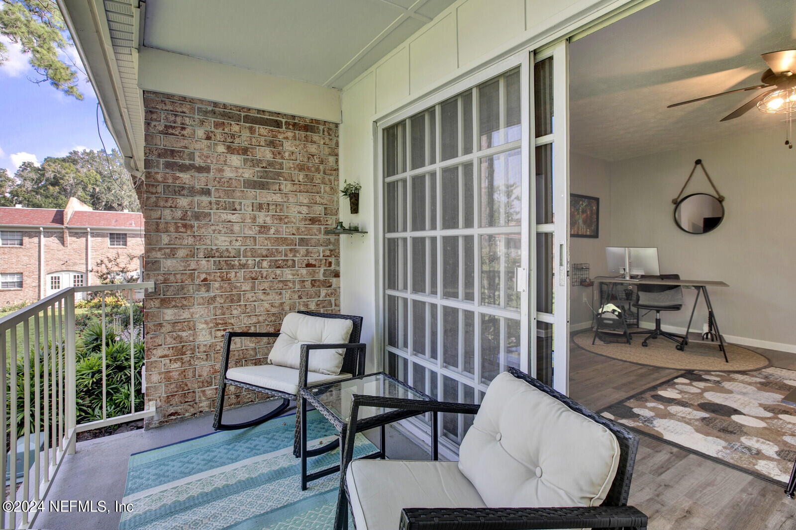 a balcony with table and chairs