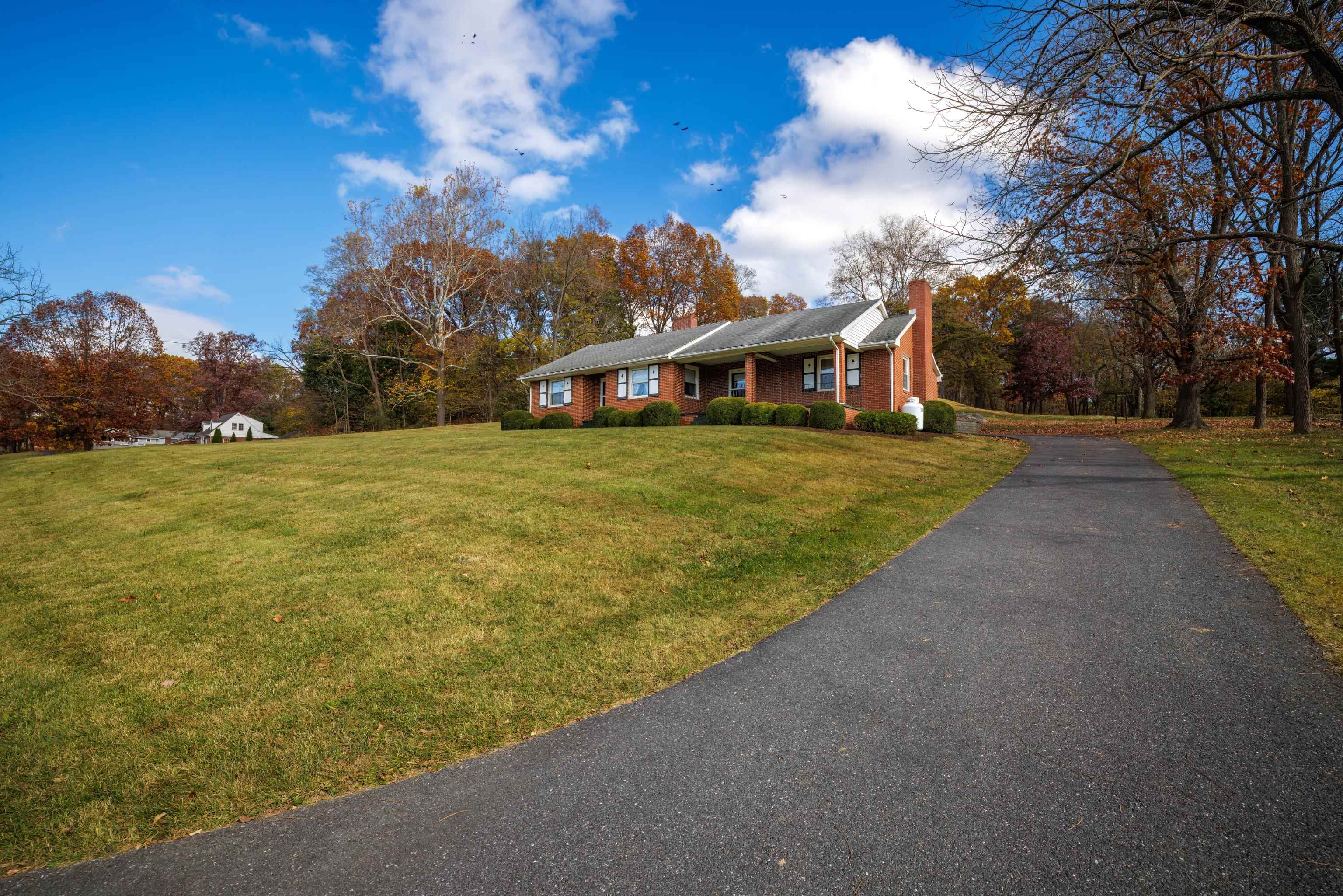 a view of a big yard with a house in the background