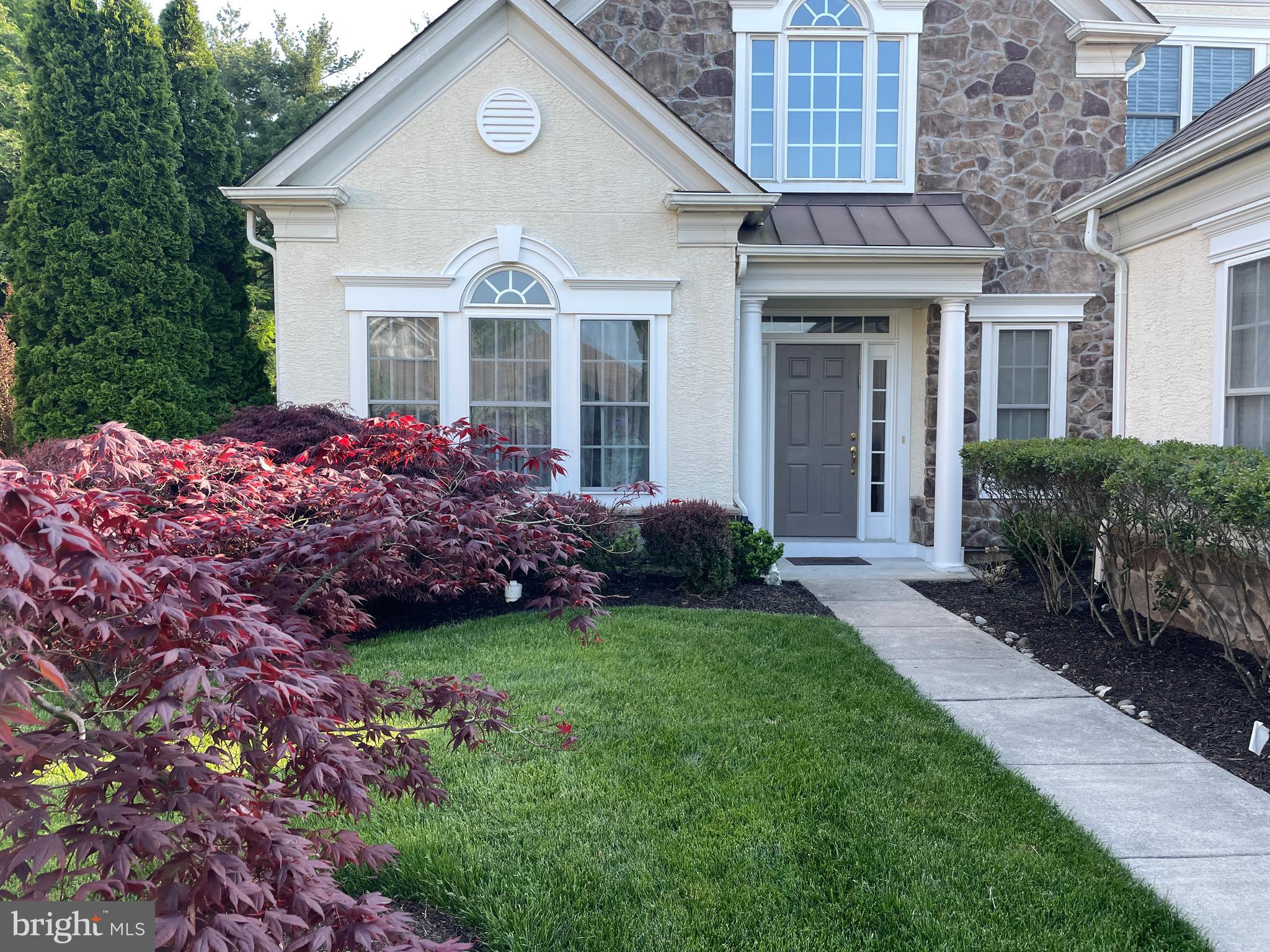 a front view of a house with a garden