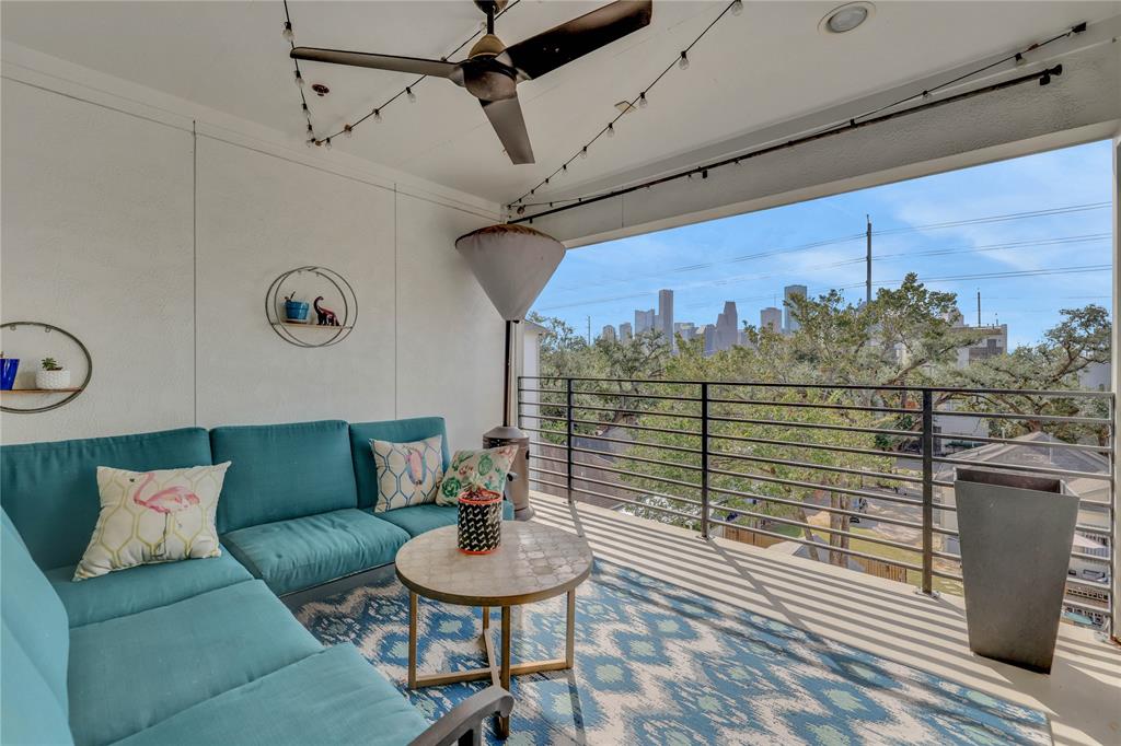 a balcony with furniture and a potted plant