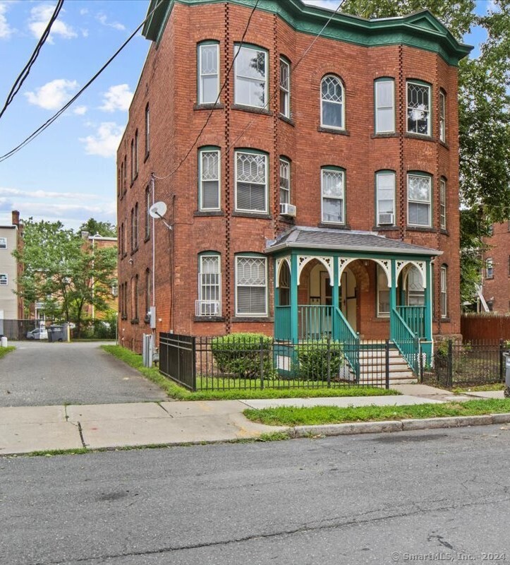 a view of a brick building next to a yard