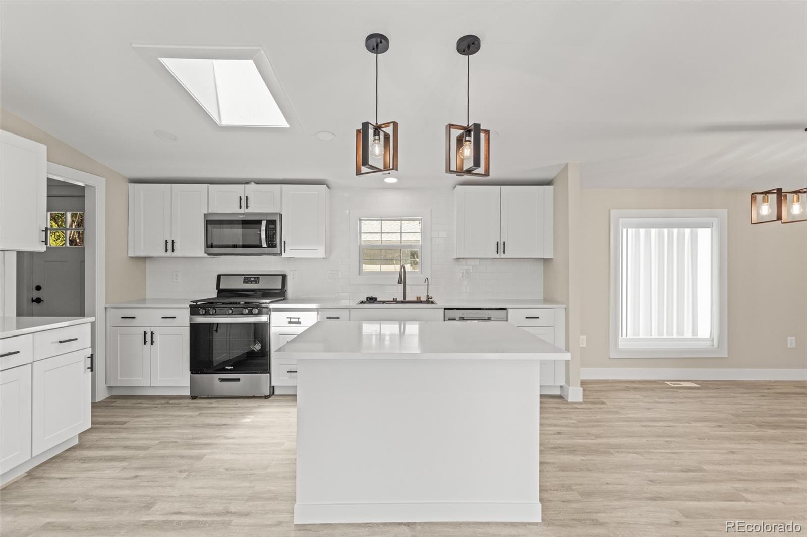 a kitchen with stainless steel appliances and white cabinets