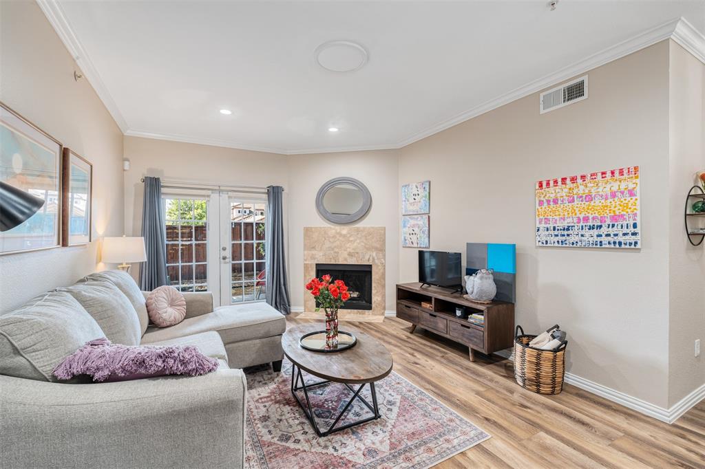 a living room with furniture a fireplace and a flat screen tv