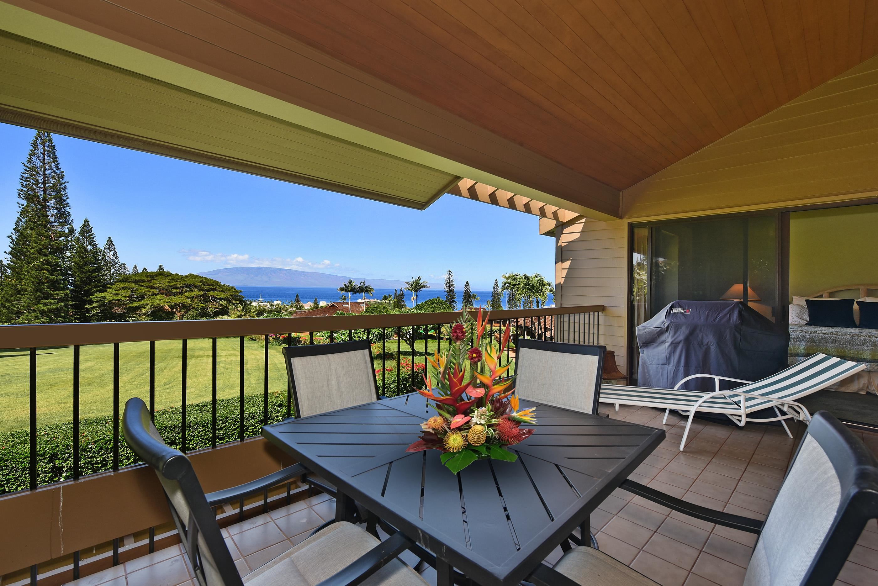 a view of a balcony with chairs and a potted plant