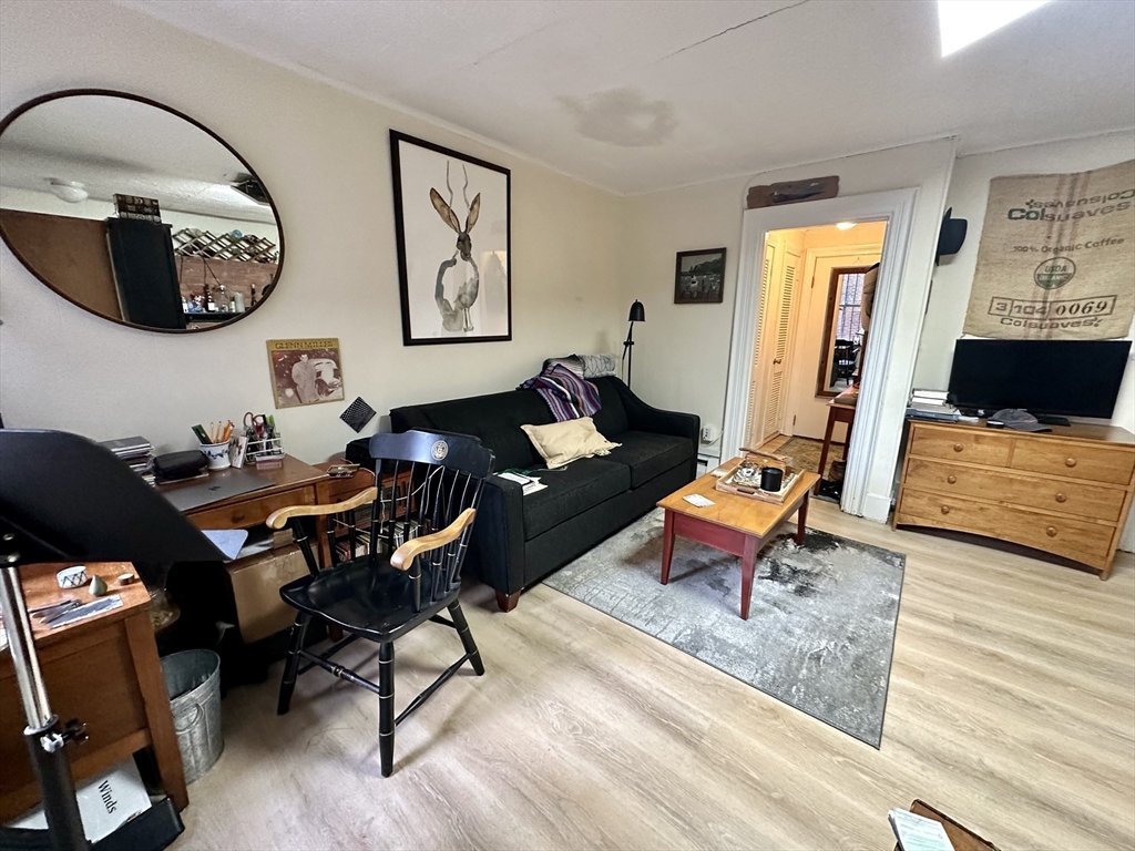 a living room with furniture and a mirror