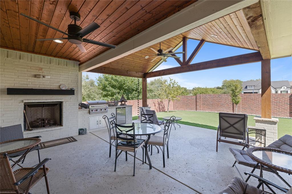 a view of a patio with a table and chairs