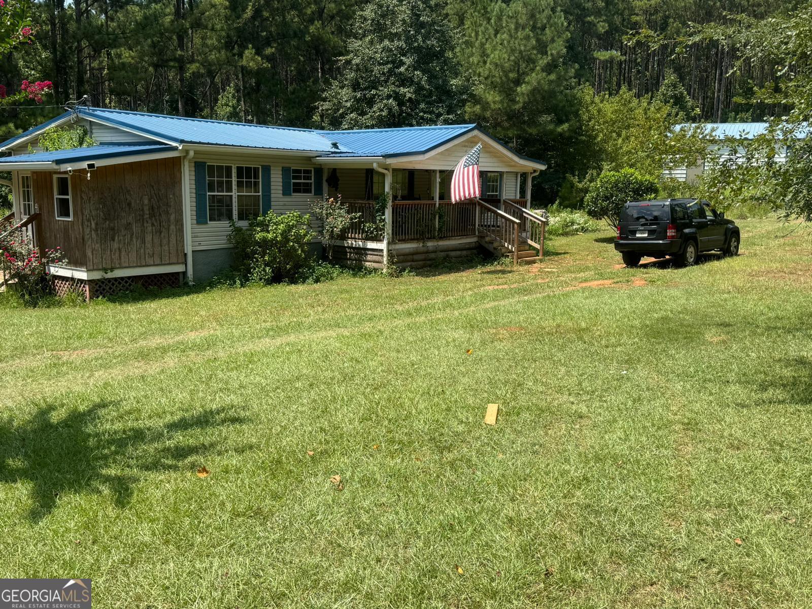 a view of a house with backyard sitting area and garden