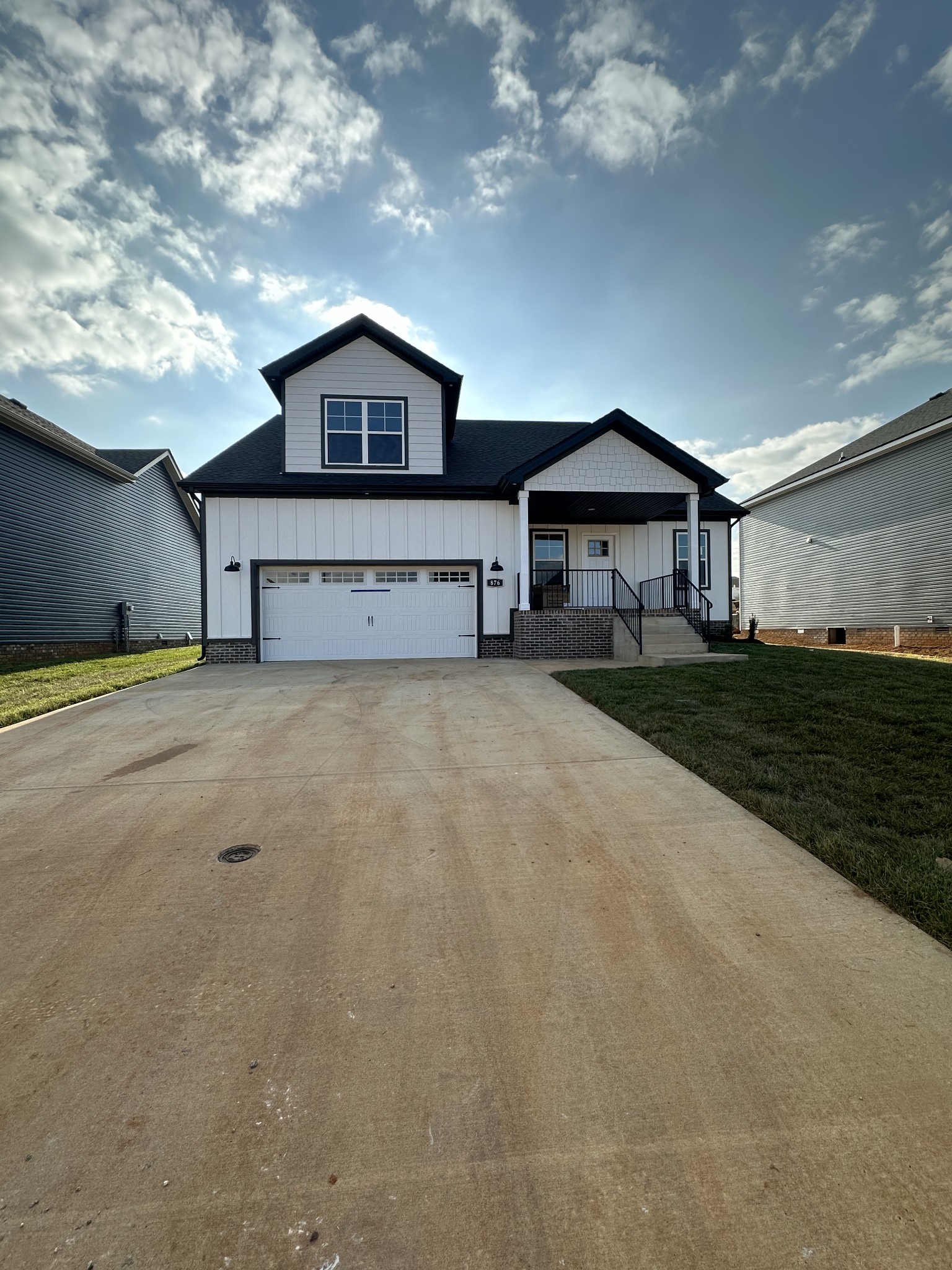 a view of house with yard and sitting area