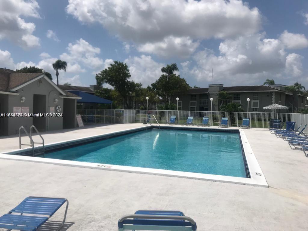 a view of a swimming pool with a yard