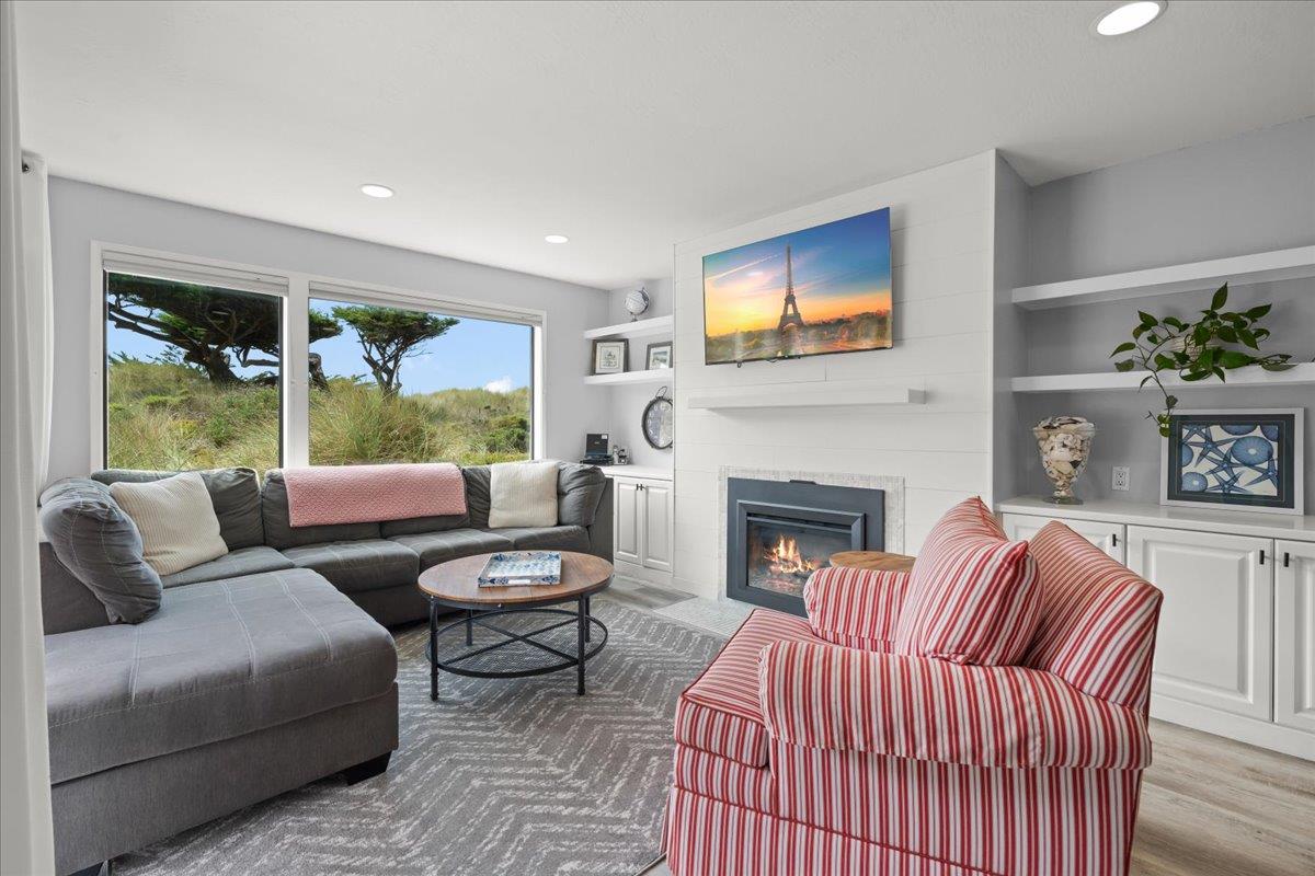 a living room with furniture fireplace and window