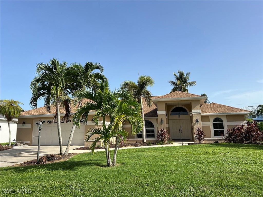 a front view of a house with a yard and garage