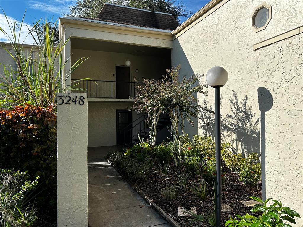 a view of front door and potted plants