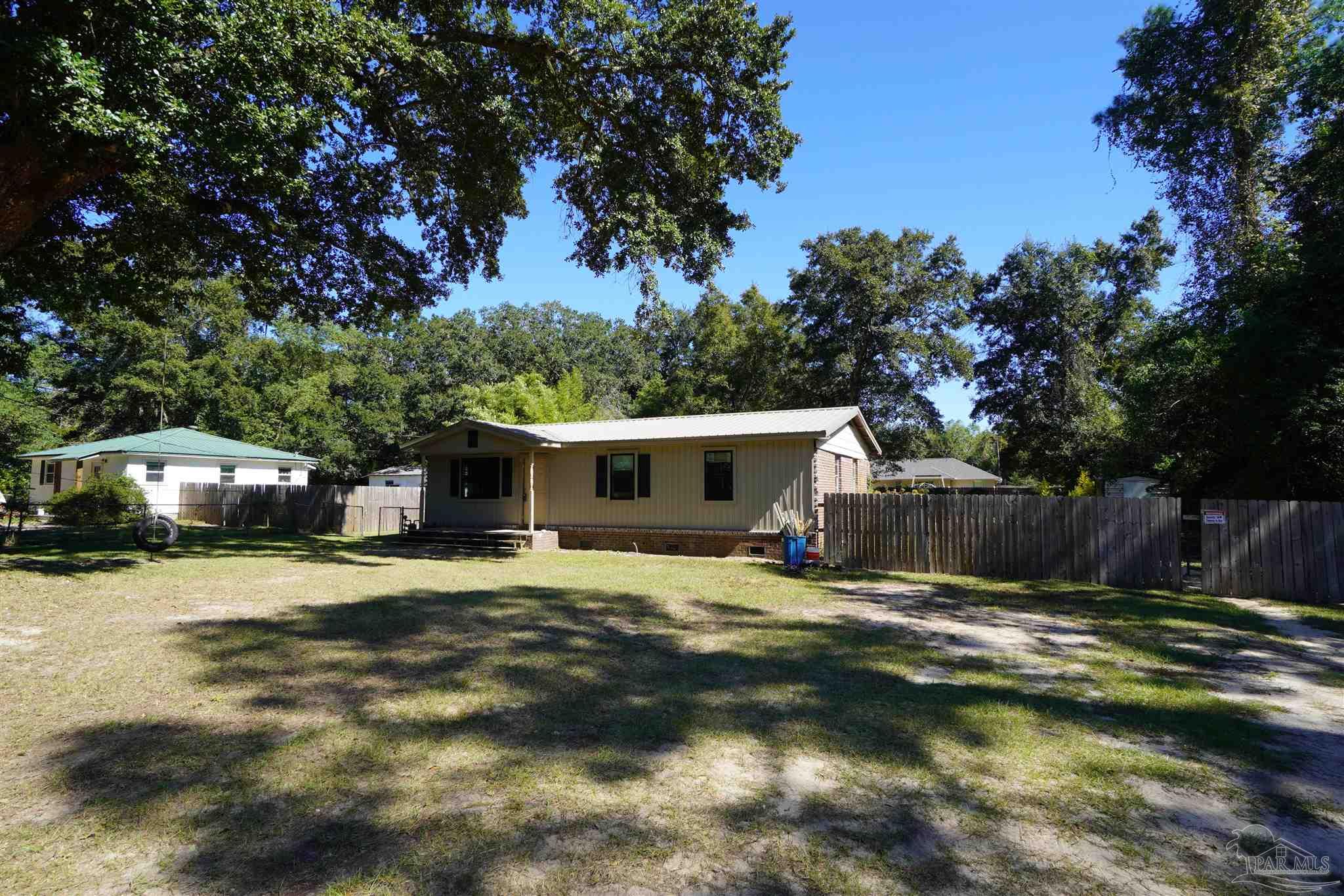 a view of a house with a yard garage and sitting area