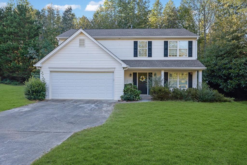 a front view of a house with a garden