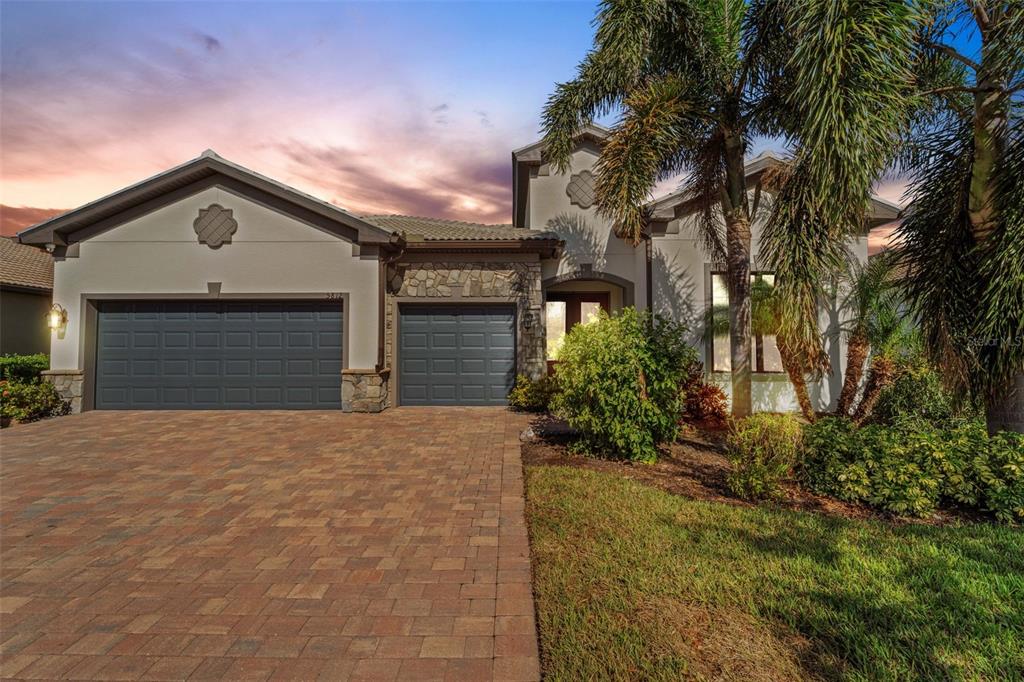 a front view of a house with a yard and garage